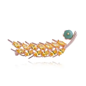Broche en épi de blé or rose avec pierres jaunes et petit accent de fleur turquoise