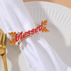 Detail of golden blessed napkin ring with orange maple leaves and sparkling rhinestones