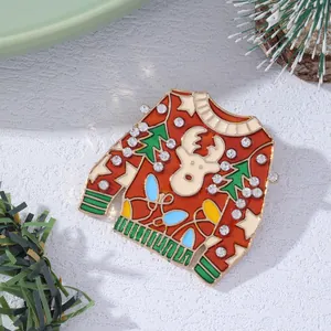 Detail of Christmas sweater brooch with reindeer and tree enamel finish and rhinestones