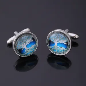 Detailed close-up of Celtic Tree of Life cufflinks with silver base and blue glass dome