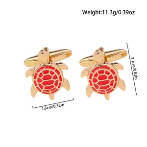 Detail shot of gold turtle cufflinks with red enamel pattern and precise measurements