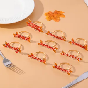 Golden Thanksgiving napkin rings set featuring maple leaves with festive text and crystals