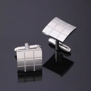 Macro view of polished silver square cufflinks featuring a 3x3 grid texture and T-bar back