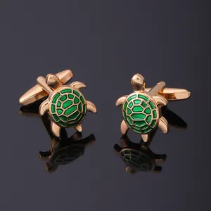 Detailed macro view of turtle cufflinks with gold finish and green enamel shell