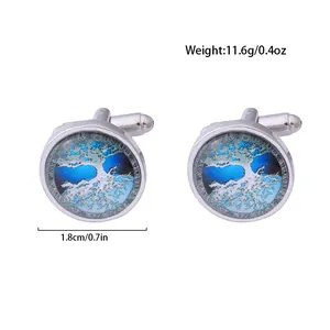 Detail view of round Celtic Tree of Life cufflinks with blue art glass and silver finish