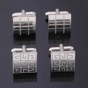 Polished silver square cufflinks set with geometric laser engraved patterns on black background