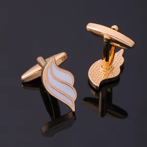 Elegant wing-shaped cufflinks in gold and white enamel, front and back view on black mirror