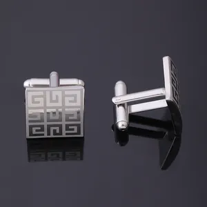 Polished silver square cufflinks with geometric pattern and bullet back on reflective base