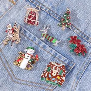 Christmas enamel brooch set with festive Santa, tree and reindeer on denim fabric
