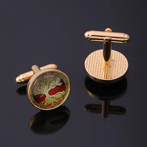 Golden Celtic Tree of Life cufflinks for men with red background on a dark reflective surface