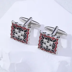 Detail of square cufflinks with red and black enamel vintage heraldic pattern on stone