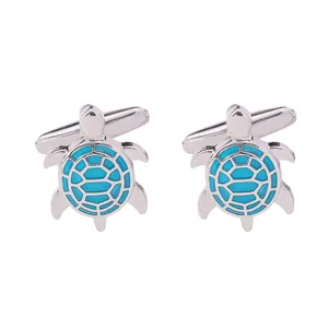 Polished silver turtle cufflinks with sky blue enamel shell patterns on white background