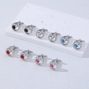 Detailed view of luxury men's round cufflinks with multi-colored crystals on white marble