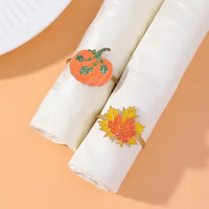 Thanksgiving napkin rings featuring orange pumpkin and colorful maple leaf designs