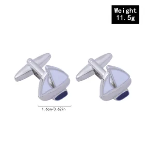Detail of silver sailboat cufflinks with white enamel and navy blue accents for men