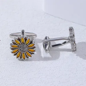 Detailed close-up of sunflower cufflinks with yellow enamel petals and silver metal base
