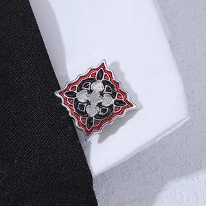 Macro shot of silver square cufflinks with red and black enamel on a textured tie