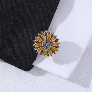 Detail of sunflower cufflinks with yellow enamel petals on a black suit jacket lapel