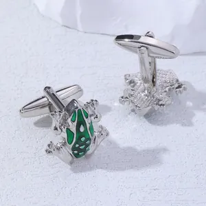 Detailed view of silver-plated frog cufflinks featuring vibrant green enamel textures