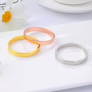 Minimalist metallic napkin rings in gold, rose gold and silver on white ceramic tray
