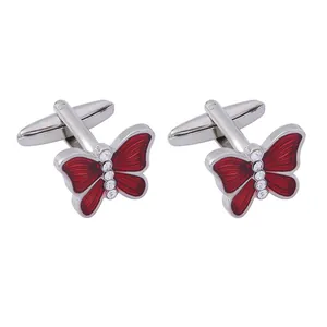 Men's silver butterfly cufflinks with red enamel wings and crystal inlay on white backdrop
