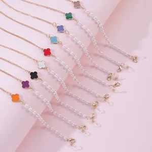 Detail of colorful four-leaf clover eyeglass chains with pearls and lobster clasps