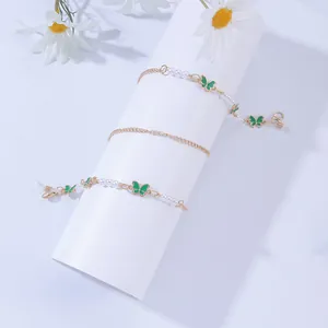 Golden pearl eyewear chain with green butterfly charms and silicone loops for children