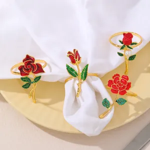Juego de cuatro servilleteros de rosa con esmalte rojo, chapado en oro y perlas