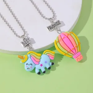 Primer plano de los collares Best Friends con dijes de unicornio y globo aerostático