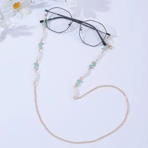 Detail of eyewear chain with blue enamel butterflies, pearls and gold link chain
