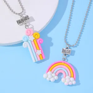 Detalle de los collares Best Friends unicornio con colgantes arcoíris sobre azul