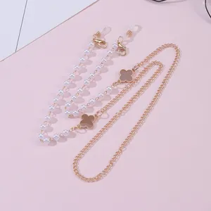 Golden four-leaf clover eyewear chain with white pearls and versatile lobster clasps