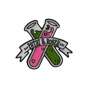 Enamel pin featuring crossed chemistry test tubes with pink and green liquid and banner