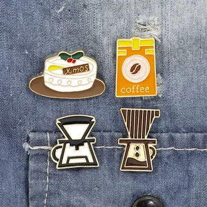 Close-up of enamel coffee and Xmas cake badges on denim fabric for a retro style