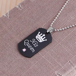 Detail of black military style dog tag necklace with His Queen engraving and pink gemstone