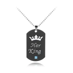 Close-up of black dog tag necklace with Her King crown engraving and blue crystal