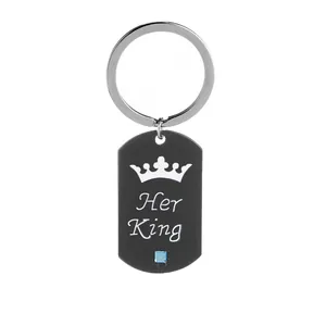 Close-up of matte black dog tag keychain with Her King crown engraving and blue crystal
