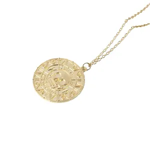 Vintage Aztec skull gold coin necklace pendant with detailed carvings on a classic chain