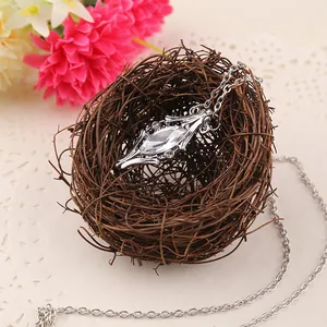 Detailed view of marquise crystal pendant nestled in a rustic nest background with flowers