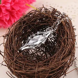 Detailed view of vintage silver crystal pendant nested in a rustic decorative bird nest