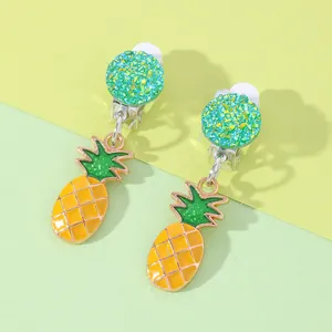 Close-up of cute yellow pineapple clip-on earrings with green glitter disc detail