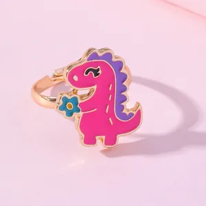 Adjustable gold ring for children featuring a cute pink cartoon dinosaur with blue flower