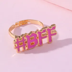 Adjustable golden ring featuring pink enamel #BFF design for best friends fashion