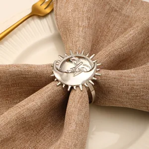 Silver sun and moon napkin ring on linen cloth with elegant holiday table setting