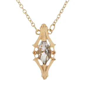 Vintage gold hollow pendant necklace with a marquise-cut crystal on a white background