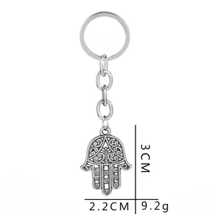 Detailed view of silver Hamsa hand keychain with hollow patterns and dimensions