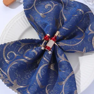 Detail of gold napkin ring featuring red enamel wine glass and sparkling zircons