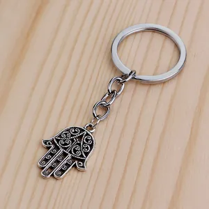 Detailed macro view of vintage silver Hamsa hand keychain with hollow floral pattern