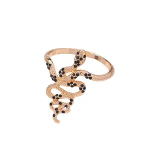 Elegant gold snake napkin ring with scale texture and black gemstones for table decor