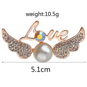 Detail of Love wing brooch with large pearl and rhinestones, weight 10.5g, width 5.1cm
